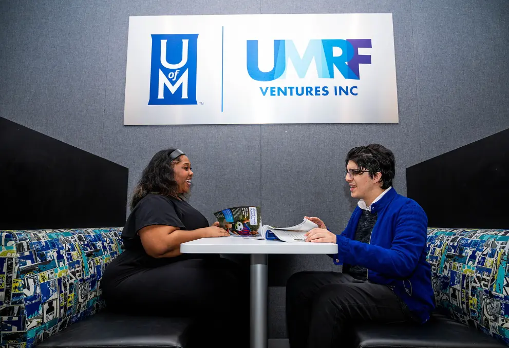 student employees talking at a table